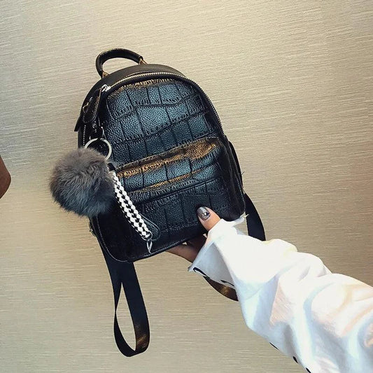 Mandotos Chic Mini Leather Backpack with adjustable straps and gold-tone hardware, perfect for casual or stylish outings.