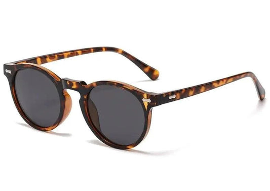 Mandotos chic round UV-block sunglasses with black frames and dark lenses, stylish and protective for outdoor wear.
