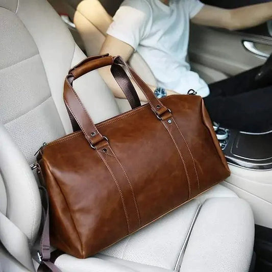 Mandotos classic leather duffel bag with sturdy handles and spacious interior, ideal for travel and weekend trips.