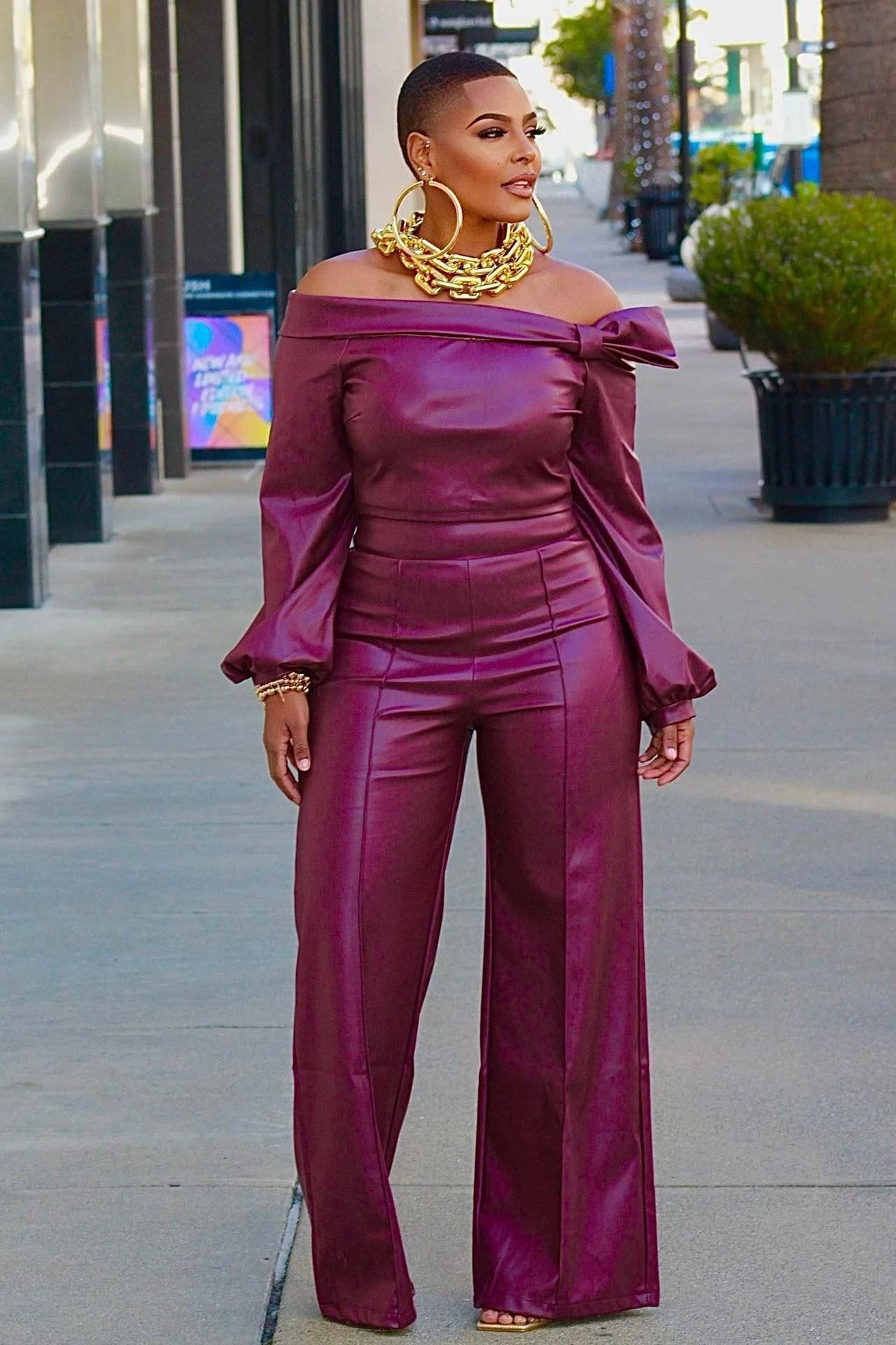 Women’s trendy leather suit by MANDOTOS, styled for a chic and confident look, featuring a sleek jacket and matching pants.