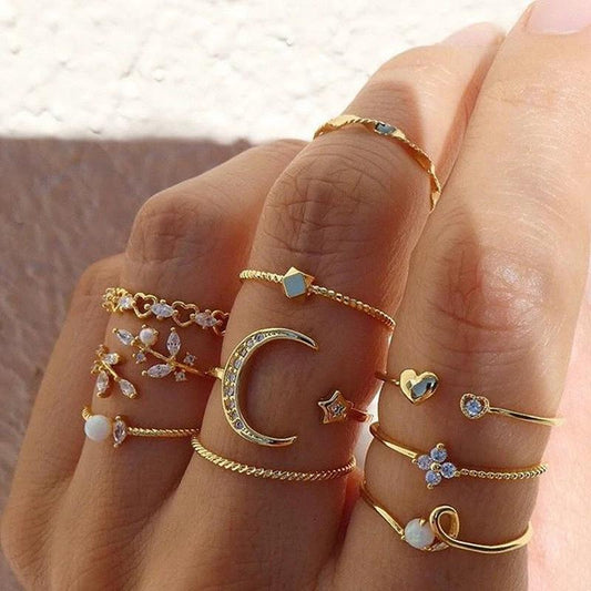 Mandotos Bohemian star, moon, pearl, and leaf stackable ring set with gold finish, featuring 10 versatile, stylish rings.