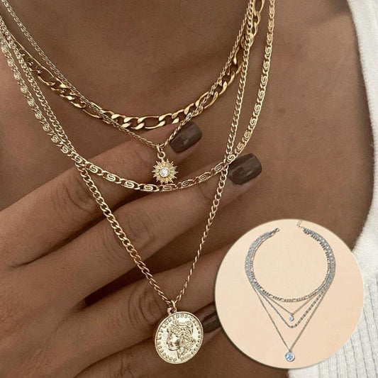 Mandotos gold layered necklace with coin pendant and sun charm, stylish jewelry for women featuring bold, chunky design.