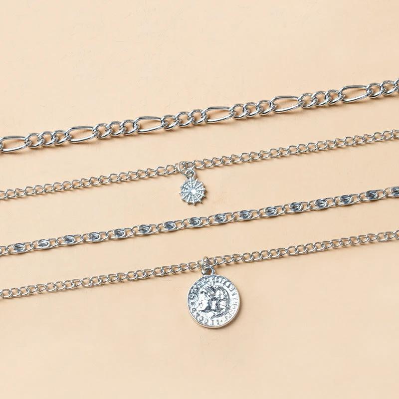 Mandotos chunky gold layered necklace featuring a coin pendant and sun charm for women, stylish jewelry accessory.