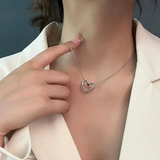 Stainless steel twist hollow heart necklace on a clavicle chain, stylish jewelry by MANDOTOS with a modern design.