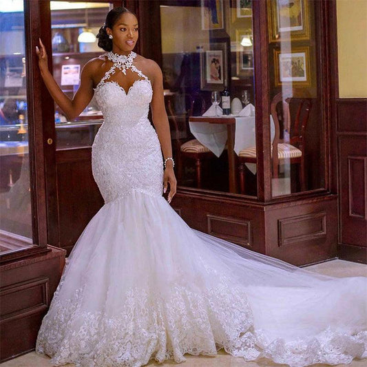 Vintage lace beaded mermaid wedding dress by MANDOTOS featuring a sheer neck, intricate beading, and elegant lace details.