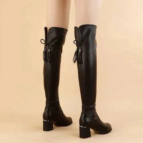 Elastic leather knee boots by MANDOTOS featuring a sleek design and comfortable fit, shown on a model with a neutral background.