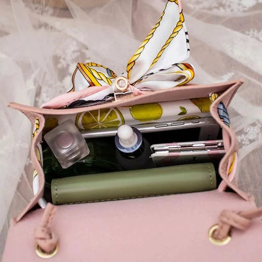 Elegant leather handbag and matching scarf by MANDOTOS, featuring stylish design and premium craftsmanship.