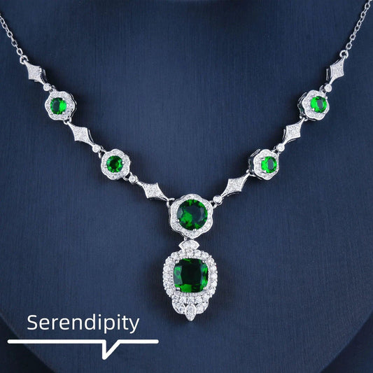 Mandotos Emerald Elegance white gold necklace featuring a central emerald gemstone and delicate chain for sophisticated style.