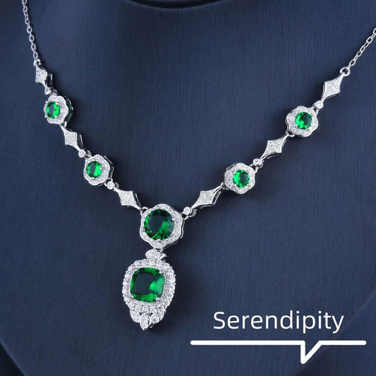 Emerald Elegance white gold necklace featuring a central emerald gemstone and intricate design by MANDOTOS.