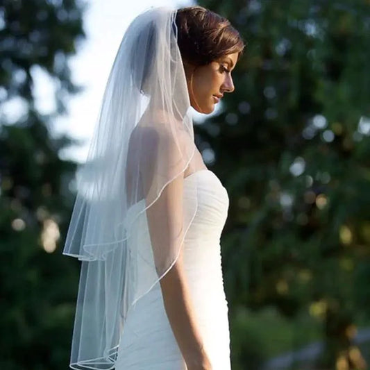 Elegant Ethereal Double Tiered Veil by MANDOTOS, lightweight tulle with layered design for bridal or formal wear.
