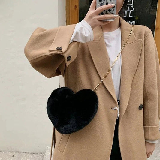 Mandotos women's heart-shaped faux fur crossbody bag with plush texture, chain shoulder strap, and tote-style design.