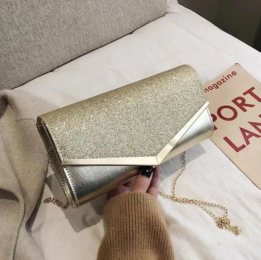 Mandotos Glitzy Striped Sequin Satchel with metallic accents and adjustable strap, featuring vibrant multicolor sequin stripes.