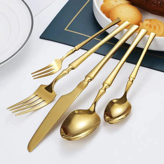 Gold Glamour 30-piece dinner set by MANDOTOS featuring elegant plates, bowls, and mugs with a luxurious gold finish.