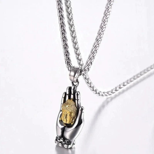 Golden Buddha pendant by MANDOTOS featuring a detailed, shiny metal pendant with intricate Buddha design on a chain.