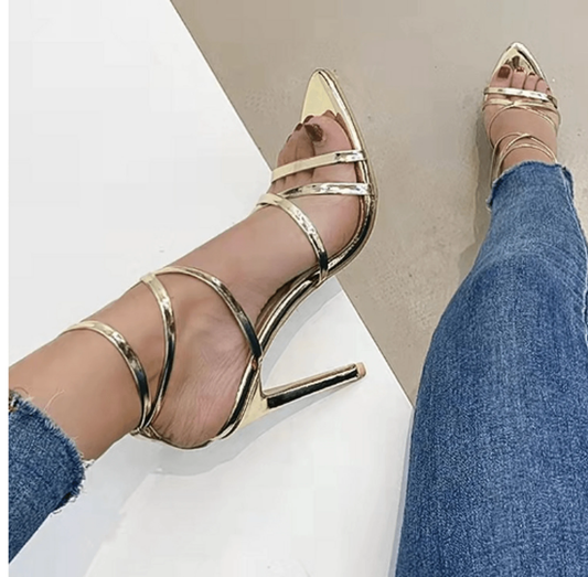 Golden strappy stiletto pumps by MANDOTOS with high heels and elegant design, perfect for formal or evening wear.