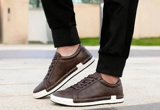 Mandotos handmade men's casual closed-toe trainers showing black leather upper and comfortable sole detail.