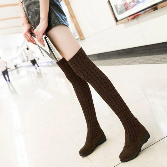 Mandotos high flat over-the-knee stretch Martin boots in black leather, featuring a sleek, fitted design with flat soles.