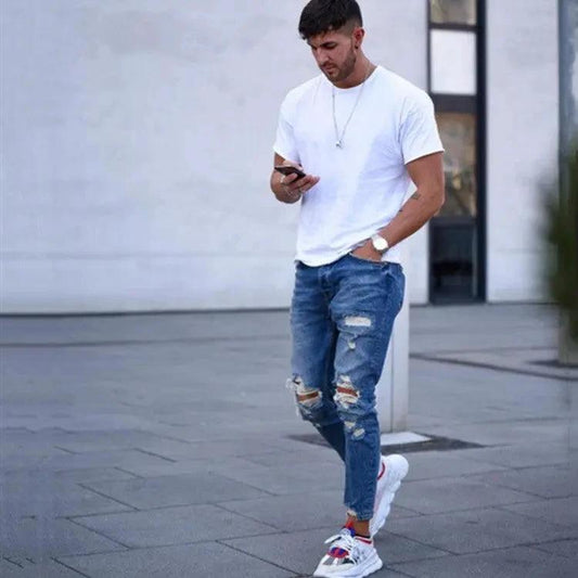 Mandotos men's jeans with stylish holes, classic fit and denim texture, displayed on a plain background.