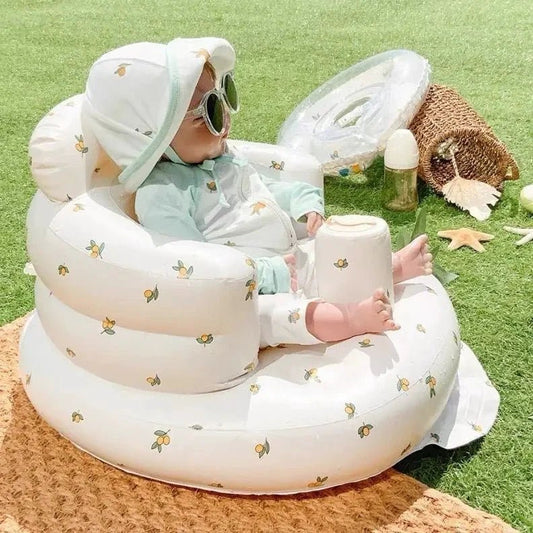 Inflatable baby chair by MANDOTOS designed for dining and bath, featuring a soft, waterproof cushion with adjustable safety straps.