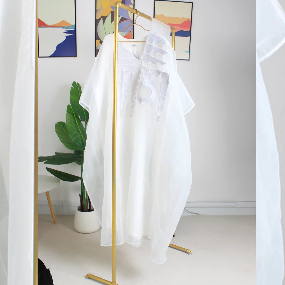 Elegant white African abaya for women with embroidery, plus size, suitable for parties or church events, by MANDOTOS INTERNATIONAL.