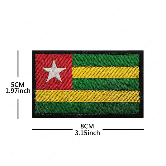 Embroidery patches featuring African flags and badges from Morocco, Nigeria, Gabon, Libya, and Namibia by MANDOTOS INTERNATIONAL.