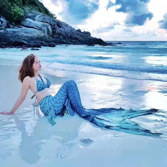Shiny mermaid tails swimsuit by MANDOTOS INTERNATIONAL featuring a colorful, scale-like pattern for swimming and costume wear.