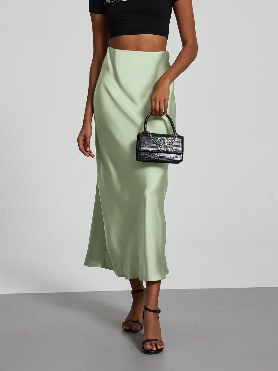 European American style satin midi skirt by MANDOTOS INTERNATIONAL, featuring a smooth, shiny fabric and elegant midi length.