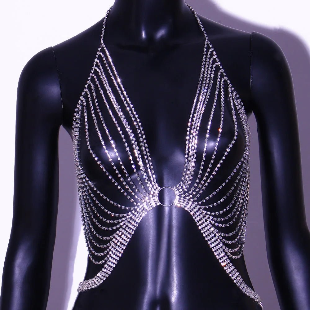 Geometric bikini chest chain by MANDOTOS INTERNATIONAL with crystal and rhinestone accents, draped over a model's torso.