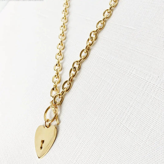 Heart-shaped key toggle necklace by MANDOTOS INTERNATIONAL featuring a delicate chain and a detailed heart key pendant.