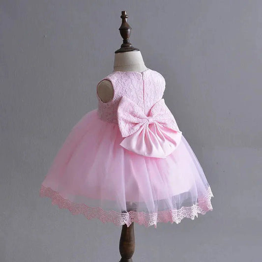 Little Princess gown by MANDOTOS INTERNATIONAL featuring a pink dress with floral details and a tulle skirt.