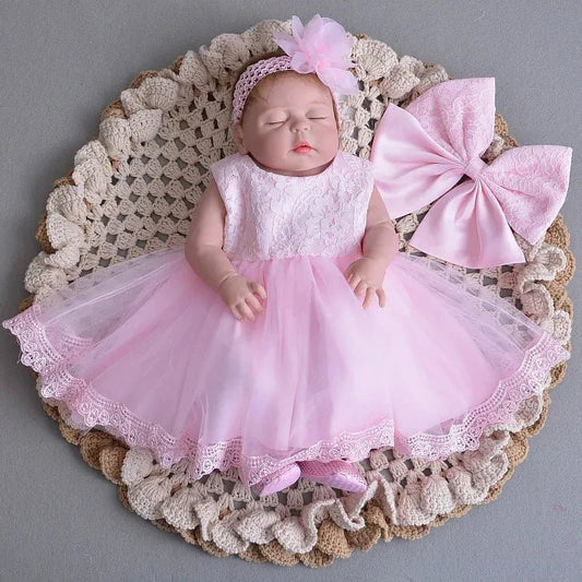 Little Princess gown by MANDOTOS INTERNATIONAL featuring a pink dress with ruffles and a cute bow for young children.