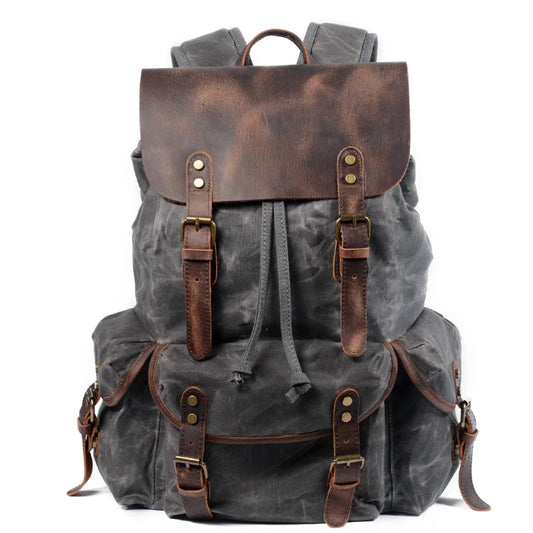 Men's vintage batik canvas and leather backpack with adjustable straps and multiple compartments from Mandotos International.