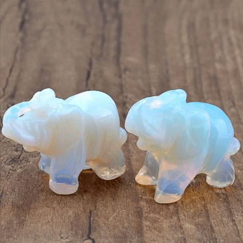 Mini elephant crystal sculpture by MANDOTOS INTERNATIONAL, clear and detailed glass figurine with intricate elephant design.
