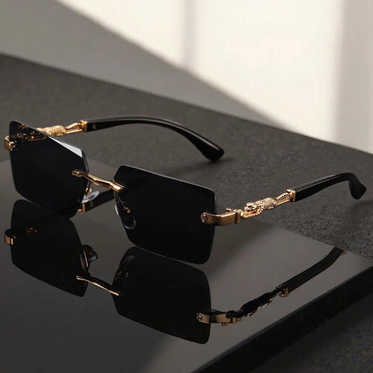 Unisex luxury frameless black and gold sunglasses with leopard print, rectangular lenses, UV400 protection, elegant design.