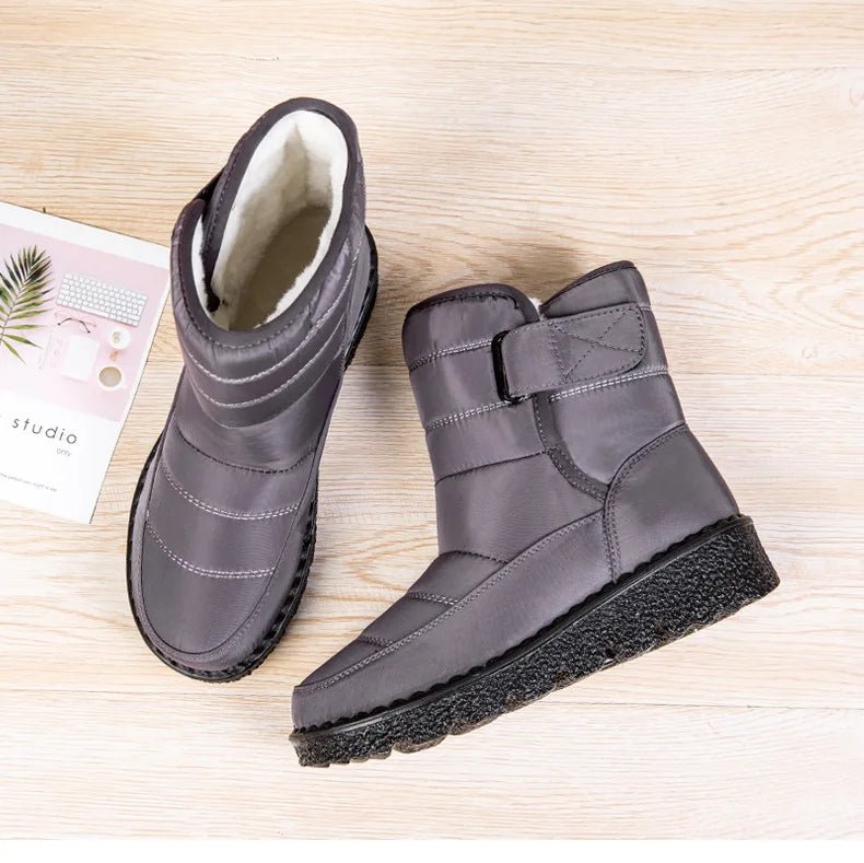 Women's waterproof winter snow boots by MANDOTOS INTERNATIONAL featuring non-slip soles, ankle height, warm lining, and platform style.