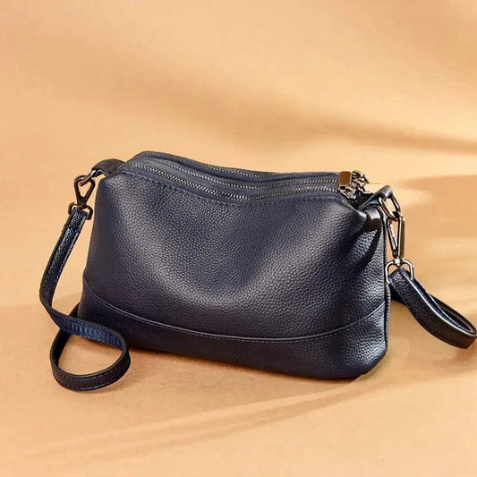 Luxury genuine leather handbag by MANDOTOS featuring sleek design and elegant craftsmanship.