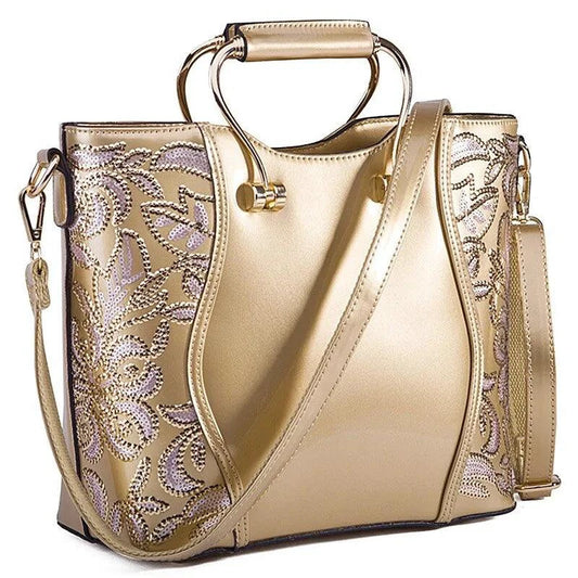 Mandotos elegant floral leather tote bag in burgundy with embroidered design and a crossbody strap for versatile style.