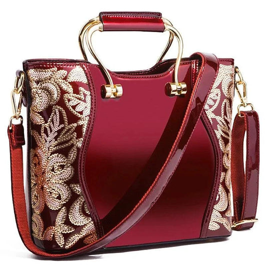 Mandotos burgundy floral leather tote bag with embroidered details and a detachable crossbody strap, stylish and spacious.