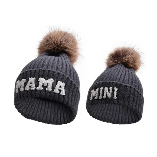 Set of three matching beanie hats for parents and baby by MANDOTOS, designed for winter warmth and family coordination.
