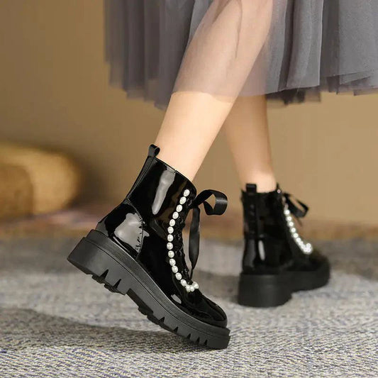 Mandotos patent leather ankle boots with sleek design, rounded toe, and low heel, perfect for stylish everyday wear.
