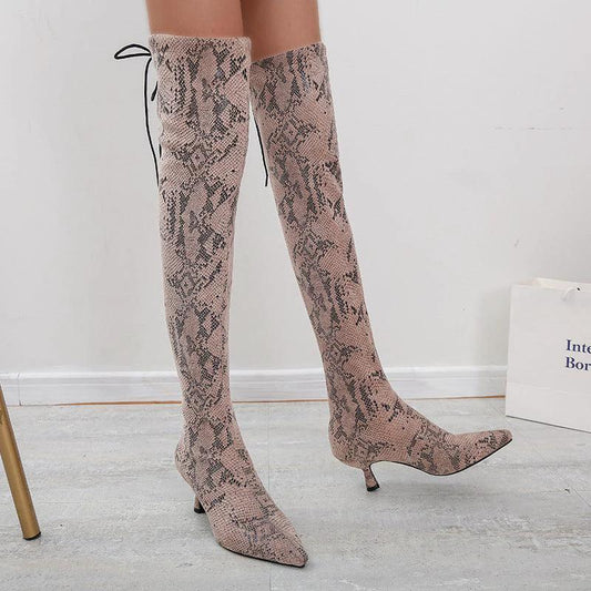 Mandotos pointed over-the-knee high-top fashion boots displayed on a model showcasing sleek black leather design.