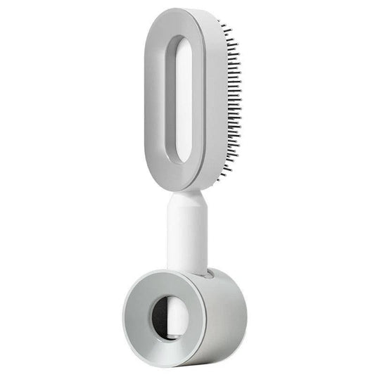 Mandotos self-cleaning hair brush with scalp massage features, showing the brush with detachable cleaning mechanism in use.