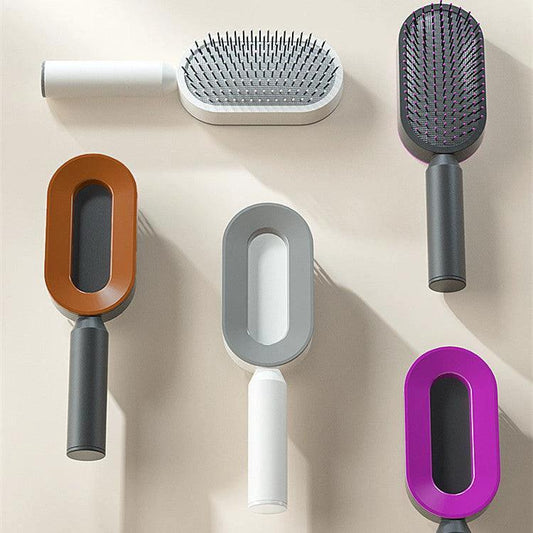Mandotos self-cleaning hair brush with scalp massage features, showing the brush head and ergonomic handle for easy grooming.