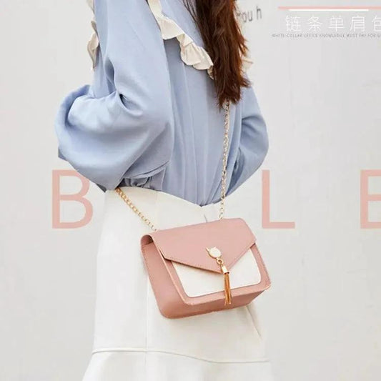 Small women's crossbody bag by MANDOTOS with a cat lock chain design and adjustable strap for casual and stylish wear.