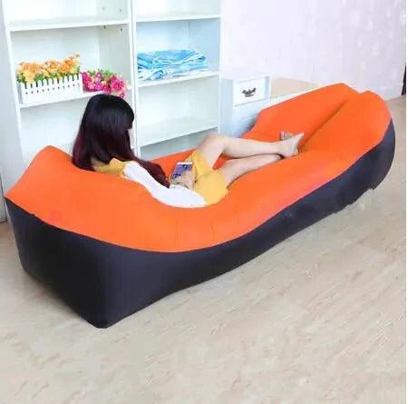 Mandotos SunScape Inflatable Lounger in vibrant orange with built-in pillow, designed for outdoor relaxation and effortless comfort.