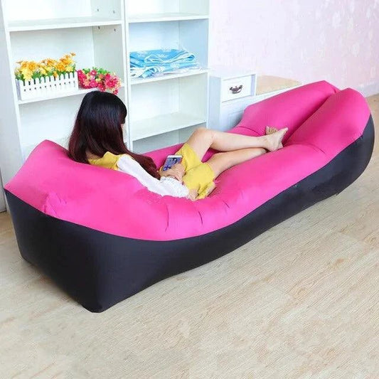 Mandotos SunScape inflatable lounger on grass, showing its lightweight design and comfortable, effortless relaxation position.