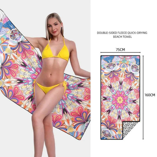 Mandotos SwiftDry patterned beach towel with colorful geometric design laid out on sandy beach