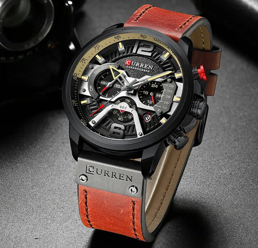 Mandotos Tactical Elegance leather watch with black dial, silver case, and brown leather strap displaying time and date.