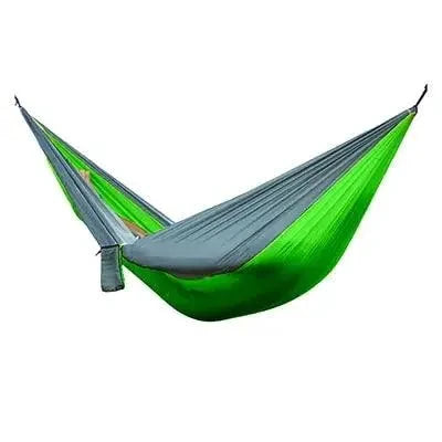 Mandotos Ultimate Oasis single and double hammock shown hanging outdoors, made of durable fabric with wooden spreader bars.