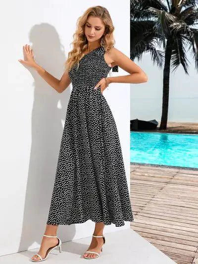 Mandotos Zoe asymmetrical midi dress in flowy fabric with layered design and unique hemline, modeled on a person.